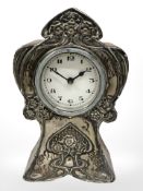 An Art Nouveau oak bedroom clock with silver mounts, height 15.5 cm.
