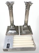 A pair of Walker & Hall silver plated corinthian column candlesticks, height 26 cm.