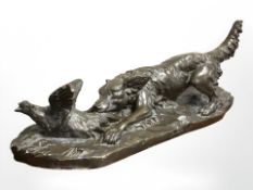 A bronze-effect pottery figure of a hound chasing a pheasant,