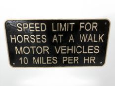 A speed limit metal sign.