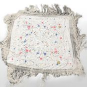 An antique embroidered silk shawl.