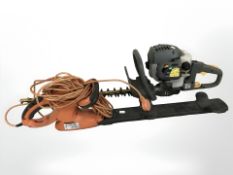 A Ryobi electric hedge trimmer and a Flymo hedge trimmer