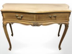 A French walnut serpentine fronted two drawer side table,