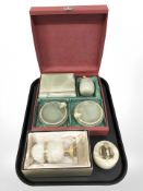 An onyx egg on gilded stand together with a table lighter and boxed set of onyx ash tray and