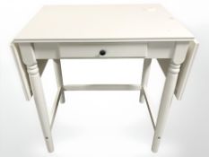 A contemporary white drop leaf table, width 69 cm,