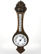 A Victorian oak aneroid barometer.