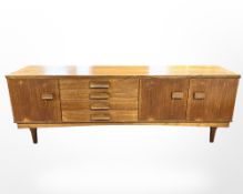A mid century teak long sideboard,