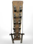 A heavy oak and iron wine rack, height 103 cm.
