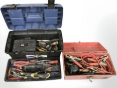 Two toolboxes containing jump leads and various tools.