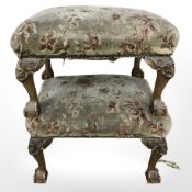A pair of early 20th century footstools on claw and ball feet,