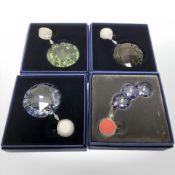 Four Swarovski Collectors Society pendants, boxed.