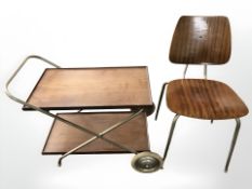 A teak two tier trolley together with a ply and metal chair.
