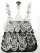 A group of crystal and glass ware including three decanters, whisky tumblers, etc.