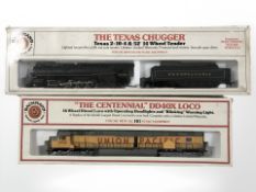 Two Bachmann HO scale locomotive engines including The Centennial DD40X loco and The Texas Chugger