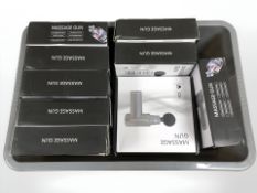 A box containing a quantity of massage guns in boxes.