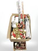 Two boxes containing Christmas decorations, baubles, wrapping paper, garlands, etc.