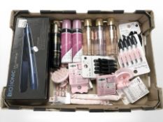 A box of new stock items including Bio Ionic pro styler hair straighteners, further hair products,