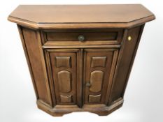 A reproduction mahogany double door cabinet,