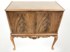 A 20th century walnut double door cocktail cabinet, width 89 cm.