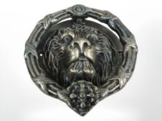 A lion head door knocker.