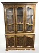 A reproduction mahogany glazed bookcase, width 133 cm.