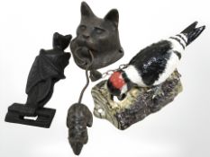 Three door knockers, cat, bird and bat.