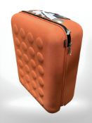 An orange travel case, new.