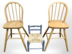 Two beech child's chairs together with a small rush seated chair