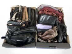 Two boxes containing leather handbags and holdalls.