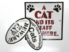 Three cast metal cat signs.