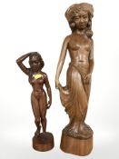 Two carved Bali figures, tallest 60 cm.