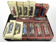 A group of models of Yesteryear die cast classic cars and matchbox vehicles.