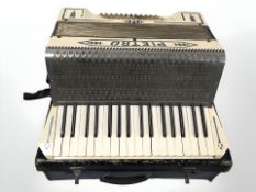 A Pietro piano accordion in case.