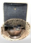 A wicker log basket together with spark guard and a copper coal helmet.