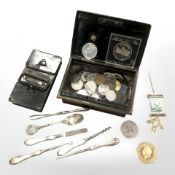 An old cash tin containing coins, silver handled manicure tools,