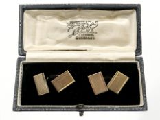 A pair of 9ct yellow gold rectangular gold cufflinks with engine turned textured fronts