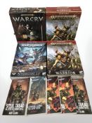 Four Warhammer box sets and related books.