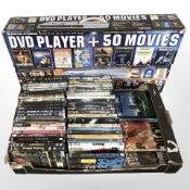 A boxed DVD player in unused condition, together with a quantity of DVDs.