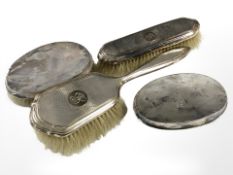 Four silver backed dressing table brushes.
