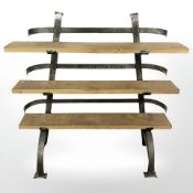 A heavy quality oak and iron three tier shelf, width 128 cm.