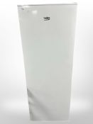 A Beko fridge, together with the user manual.