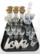 A group of glass including cut crystal decanter, liqueur glasses, champagne flutes.