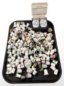 A collection of porcelain thimbles, china doll top figures, Royal Worcester egg coddlers.