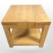 A contemporary oak veneered lamp table, width 55 cm.
