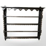 A 1920's oak plate rack with barley twist supports,