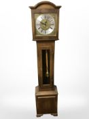 A reproduction grandmother clock with brass and silvered dial,