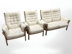 A three piece Ercol lounge suite. CONDITION REPORT: Upholstery needs attention.