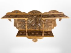 A continental carved two tier wall shelf,