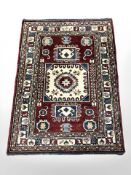 An Afghan rug of geometric design, 140 cm x 102 cm.