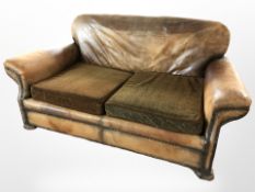 A 1920's three piece lounge suite upholstered in brown studded leather CONDITION REPORT: